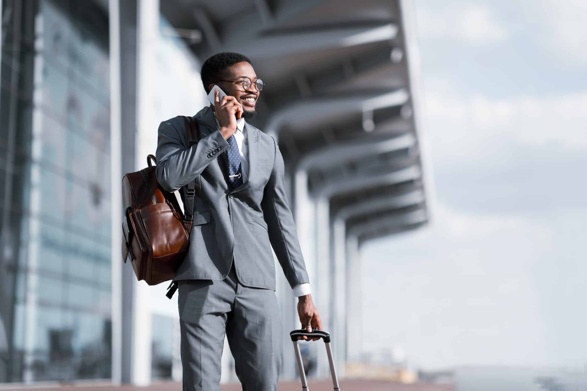 Travelling Businessman. African Man Talking on Phone