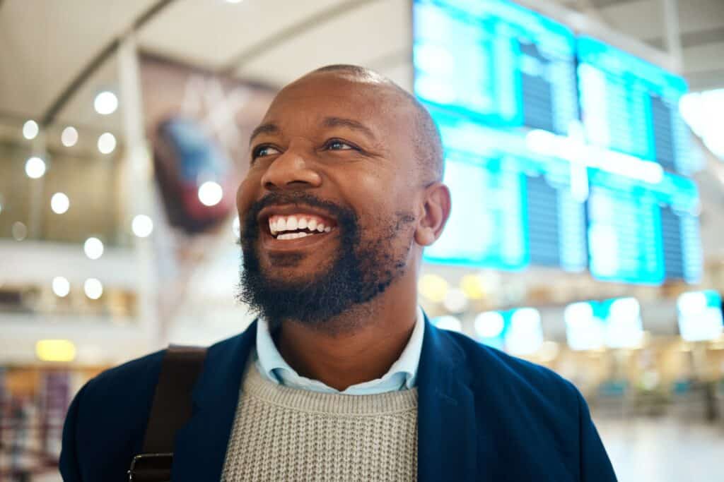 Travel, smile and happy black man in airport for international traveling or global journey. Face, i